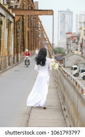 The girl in traditional Vietnamese dress with lily flowers ( Hoa loa Ken ) in April every year in Hanoi, Vietnam