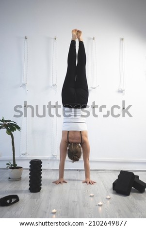 girl training in yoga studio.  Healthy and Yoga Concept. girl doing handstand
