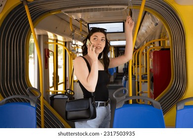 the girl in the tram is talking on the phone