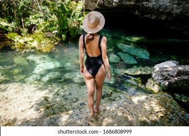 girl travel in Mexico and visit cenotes on the Yucatan peninsula. Sacred places of the Mayans. Unknown Mexico. Guy and girl in the jungle. 