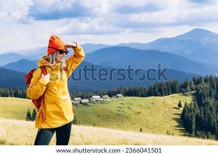 Girl Traveler hiking with backpack at the mountains landscape. Travel Lifestyle concept adventure summer vacations outdoor