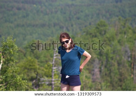 Girl traveler on the mountain in sunglasses