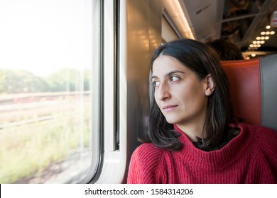 Girl Traveling By Train Looks Outside The Window