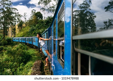 The girl travels by train to beautiful places. Beautiful girl traveling by train among mountains. Travel by train. Travelling to Asia. Trains Sri Lanka. Railway transport. Railway. Transport Asia
