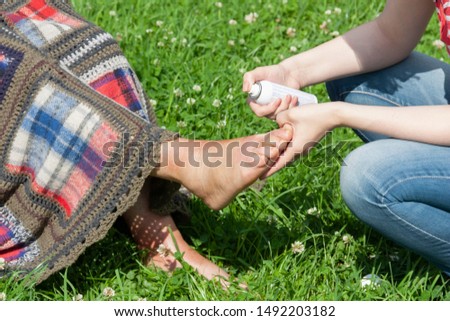A girl treats the elder woman who got a scald of leg