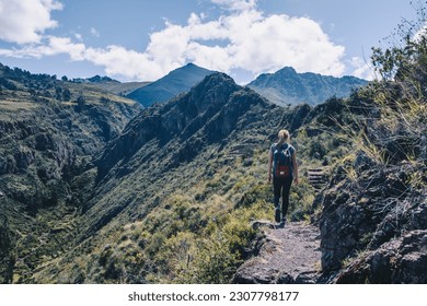 Girl trekking across Sacred Valley