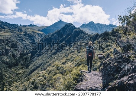 Girl trekking across Sacred Valley