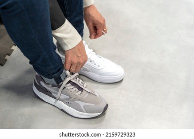 A Girl Tries On New Sneakers In A Sportswear Store 