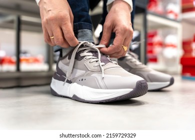 A Girl Tries On New Sneakers In A Sportswear Store 