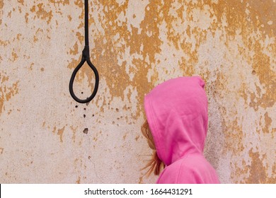 Girl trying to commit suicide. Woman in hood with the rope to hang herself. Mental disorders caused by depression, bipolar, schizophrenia, personality disorders, anxiety. Suicidal person. Hanging