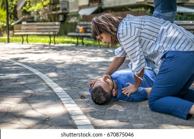 Girl Trying To Find Help For An Unconscious Guy