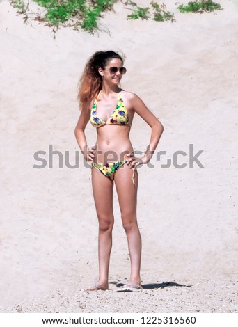 Similar – Brunette surfer woman with top and bikini holding surfboard