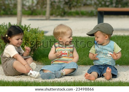 Similar – children playing in the sand, having a conversation over sand toys