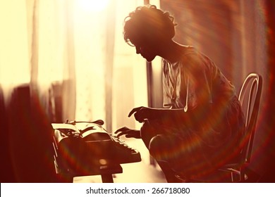 Girl Typing On A Typewriter