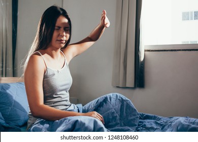 Girl upset waking up with the light bothering her lying on a bed in the morning