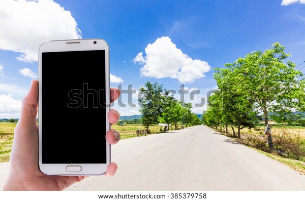 Girl use mobile
phone, the road as
background.