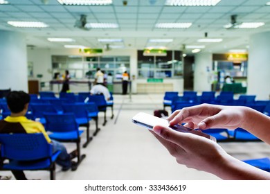 Girl use smart phone , blur image on the hospital is background. - Powered by Shutterstock