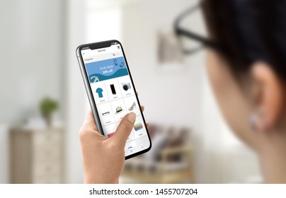 Girl uses modern shopping, online store app to buy shoes, clothes, tech. Store app concept with categories and a deal banner on the header. - Shutterstock ID 1455707204
