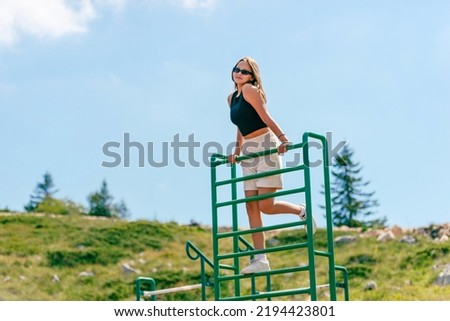 Girl uses a playground stairs on a children's playground