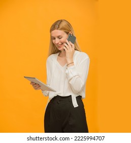 girl uses tablet smartphone isolated.smiling joyful blonde woman with long hair holds a tablet isolated - Shutterstock ID 2225994707