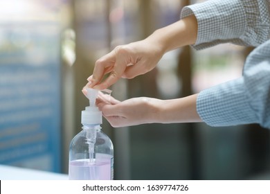 A girl using alcohol gel for cleaning hands