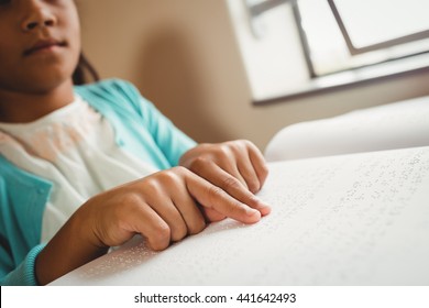 Girl using braille to read at school - Powered by Shutterstock