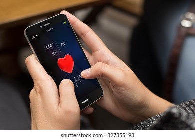 Girl Using A Digital Generated Phone With Health App On The Screen. All Screen Graphics Are Made Up.