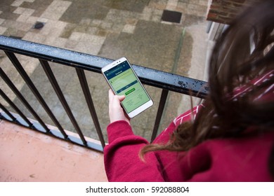 Girl Using Facebbok, The Opponent Of Snapchat. 