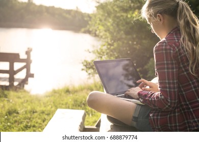 Girl Using Her Laptop Outside At Summer Vacation