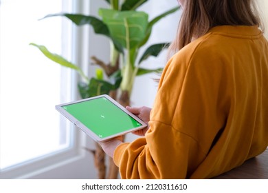 Girl Using IPad Tablet Viewing Green Screen Press Browsing Chroma Key Online Typing Text Reading Social Media Close Up Hands 13.12.21 St.Petersburg Russia.