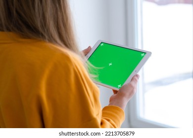 Girl Using IPad Tablet Viewing Green Screen Press Browsing Chroma Key Online Typing Text Reading Social Media Close Up Hands 13.12.21 St.Petersburg Russia.