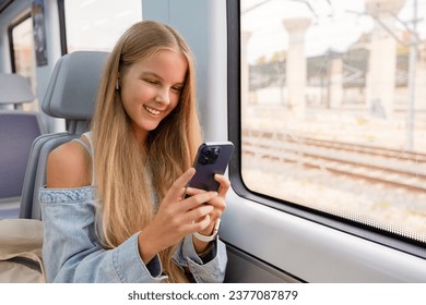 Girl using mobile phone in train - Powered by Shutterstock