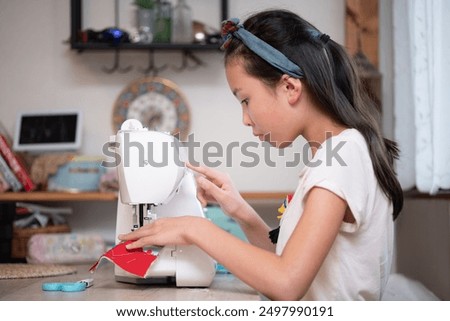 Girl using a sewing machine
