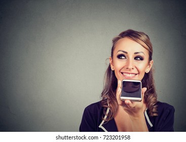 Girl Using A Smart Phone Voice Recognition Function Online On Gray Wall Background