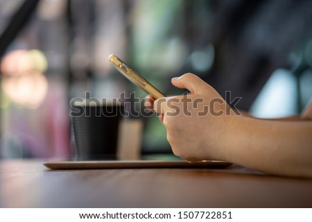 girl using smartphone in cafe. Black screen. 
