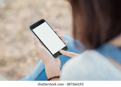girl using smartphone outdoors. white screen. 