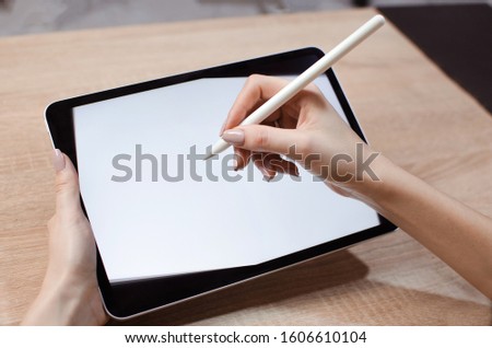 Girl using stylus on tablet to draw her ideas