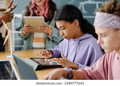 Girl using tablet pc at class - Powered by Shutterstock