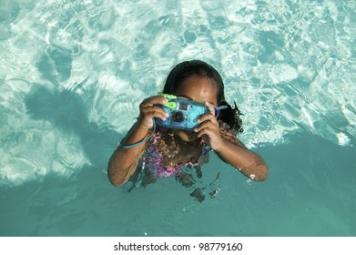 Girl Using Waterproof Camera In Swimming Pool