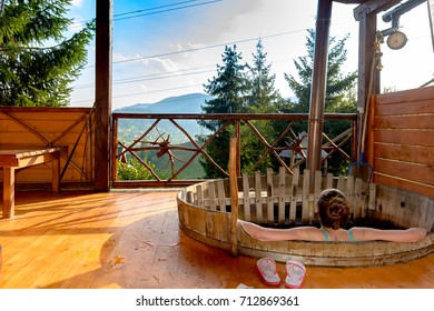 The Girl In The Vat Of Hot Water Takes A Bath In The Open Air.