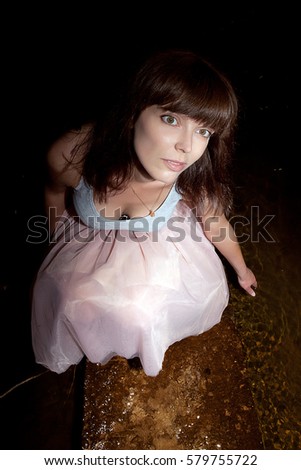 girl with views of breast in dress on dark background