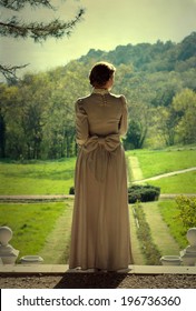 Girl In Vintage Dress Walking In The Park