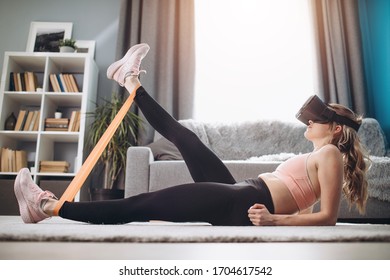 Girl In Virtual Glasses Stretching Legs With Elastic Band