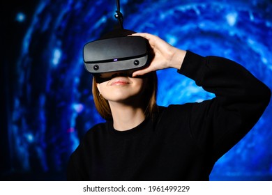 Girl In Virtual Reality Glasses, Gaming Gadget. Blue Background