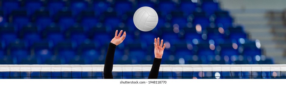 Girl Volleyball player and setter setting the ball for a spiker during a game. Professional sport concept