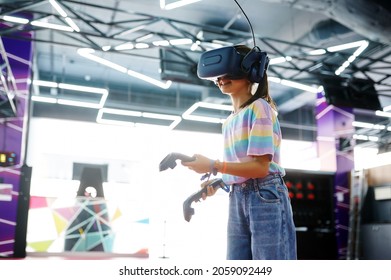 Girl in vr glasses holds joysticks in her hands - Powered by Shutterstock