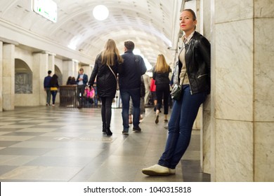 A girl is waiting for a young man in the lobby of the metro station - Shutterstock ID 1040315818