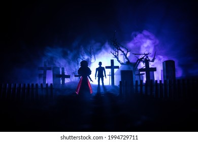 Girl Walking Alone In The Cemetery At Night. Dark Toned Foggy Background. Horror Halloween Concept. Creative Artwork Decoration