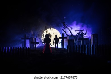 Girl Walking Alone In The Cemetery At Night. Dark Toned Foggy Background. Horror Halloween Concept. Creative Artwork Decoration