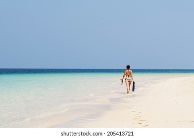 A Girl Walking At The Beach With Snorkeling Gear